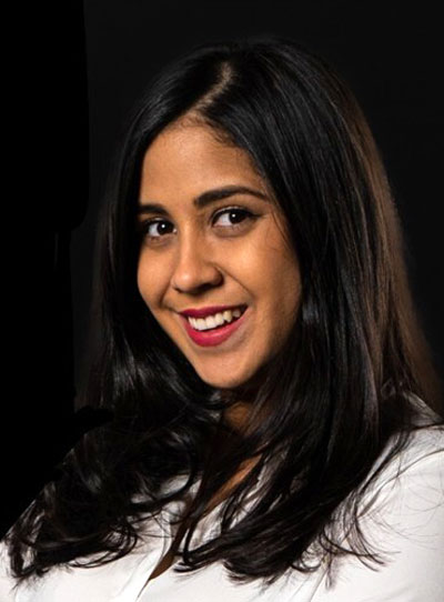 young woman smiling with long black hair